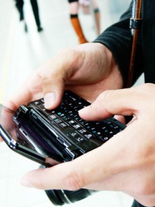 Hands typing email on mobile