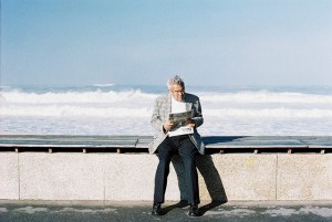 man reading water clouds outside