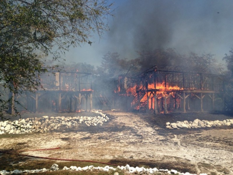 McAfee's home in Belize, burning.