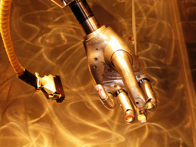 robot robotic hand gold AI artificial intelligence connected internet of things wired