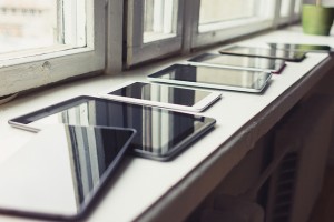 tablets lined up on a window sill ledge