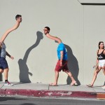 rubber neck stretch text strain long people walking street photography