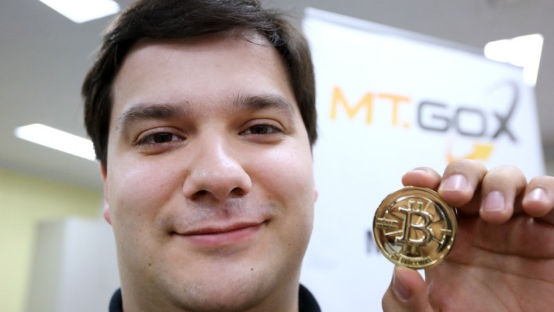 Mark Karpeles, chief executive officer of Tibanne Co., poses for a photograph with a bitcoin in the office operating the Mt.Gox K.K. bitcoin exchange in Tokyo, Japan, on Thursday, April 25, 2013. Bitcoin digital currency, which carries the unofficial ticker symbol of BTC, was unveiled in 2009 by an unidentified programmer, or group of programmers, under the name of Satoshi Nakamoto. Supply is capped at 21 million Bitcoins and managed by a software algorithm embedded into the digital currency?s design, rather than a monetary authority such as a central bank. Photographer: Tomohiro Ohsumi/Bloomberg via Getty Images