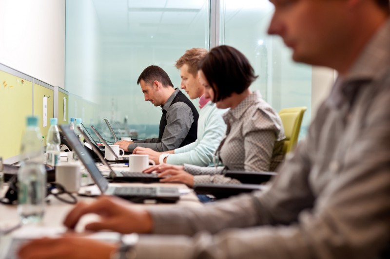 Office workers at laptops.