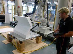 Texas A&M architecture student William Palmer guides a wire-cutting robot.